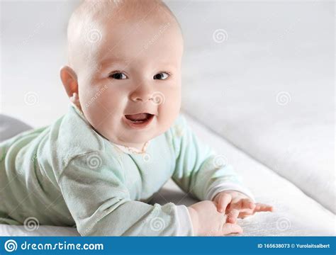 Close Upportrait Of A Pretty Little Baby On Blurred Background Stock