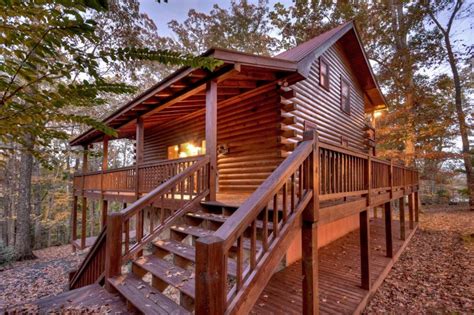 Secluded cabin on its own little island and a walking bridge that's lit up at night. Blue Lake Cabin in Blue Ridge - North GA Cabin Rental