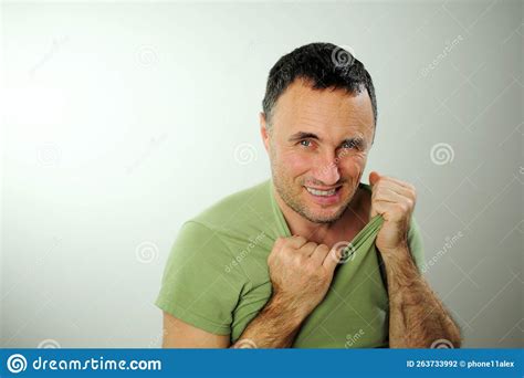 Sly Funny Look Adult Unshaven Man Tears Green Khaki T Shirt And Bites His Fingers 40 49 Years