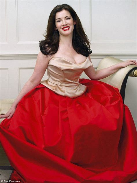 a woman in a red dress sitting on a chair