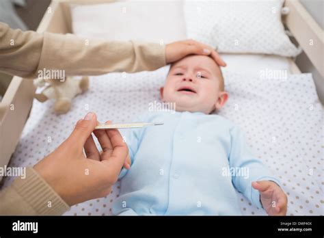 Mother Checking Babys Temperature Stock Photo Alamy