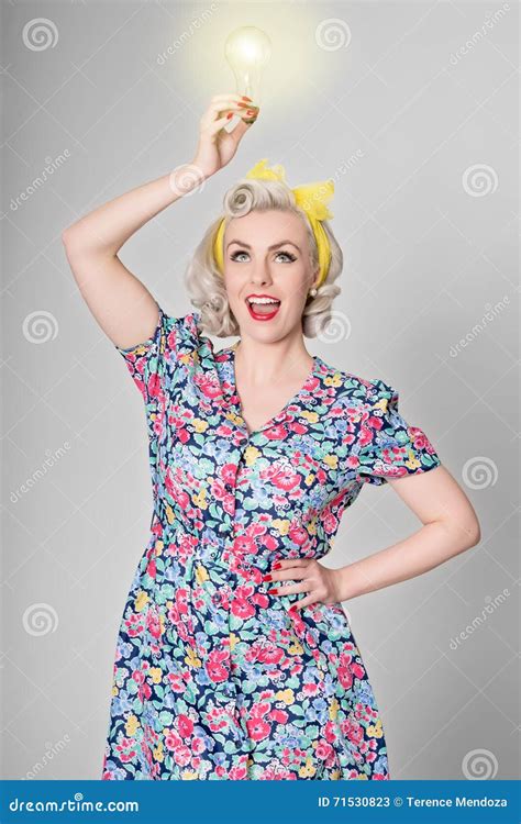 cute blonde retro girl holding glowing light bulb humorous concept stock image image of idea