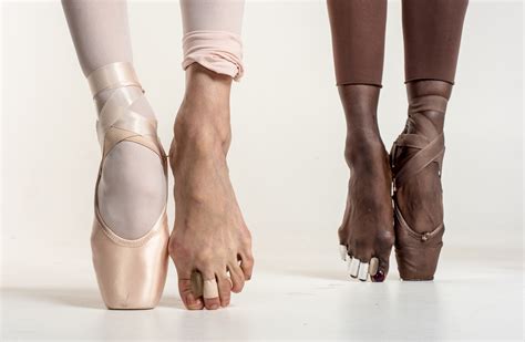 Ballet dancer tying pointe shoes in light studio. Newsela | What's the pointe? Ballet dancers suffer greatly ...
