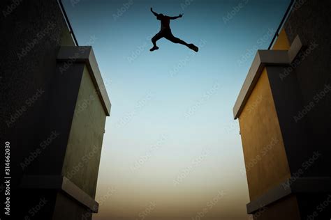 Concept Of Jumping Over Obstacles The Silhouette Of A Man Jumping