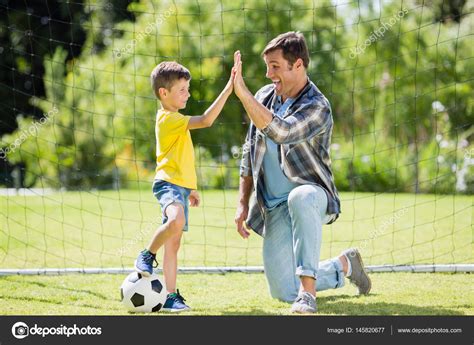 Father And Son Giving High Five Stock Photo By ©wavebreakmedia 145820677