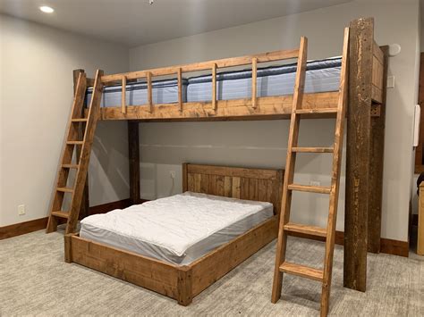 There Is A Bunk Bed With A Ladder In The Room And Another Mattress On The Floor Next To It