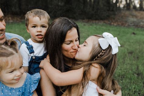 Little Girl Kissing Mom By Stocksy Contributor Erin Drago Stocksy