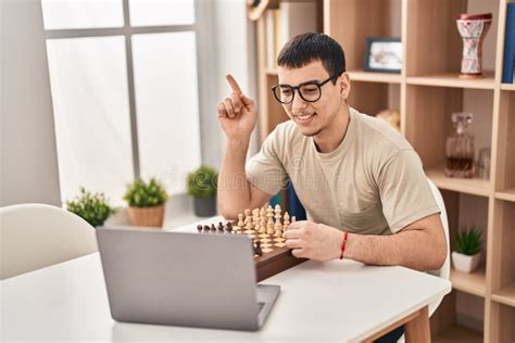 Young Arab Man Playing Chess Online Smiling Happy Pointing With Hand