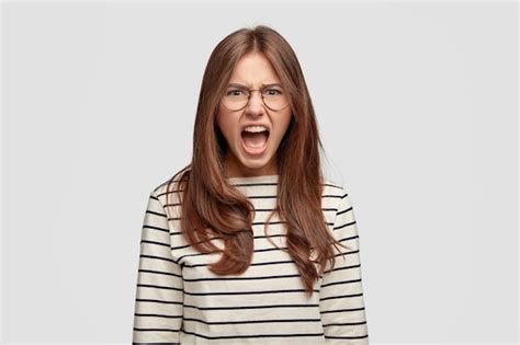 Free Photo Portrait Of Emotional Brunette Woman Screams Very Loudly Has Discontent Expression