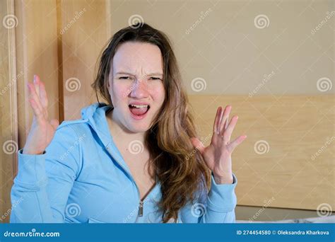 redhead woman wearing easter rabbit ears at home annoyed and frustrated shouting with anger
