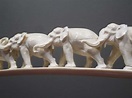 An ivory elephant tusk carved with twelve graduated elephants on a ...