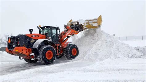 Snow plow, snow removal at shopping mall in snow storm/Montreal/Quebec