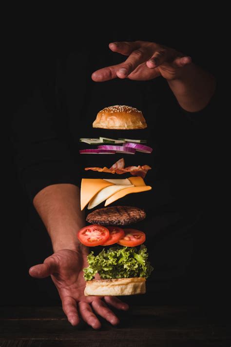Timelapse Photo Of Man Holding Burger Photo Free Food Image On