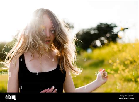 Teenage Girl Frolicking In Meadow Stock Photo Alamy