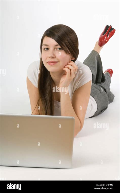 Woman Lying Down While Using A Laptop Stock Photo Alamy