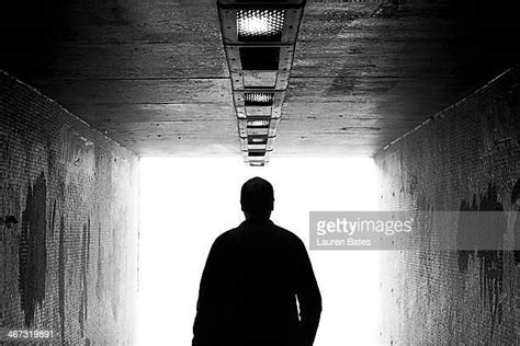 Man Walking Towards The Light Photos And Premium High Res Pictures