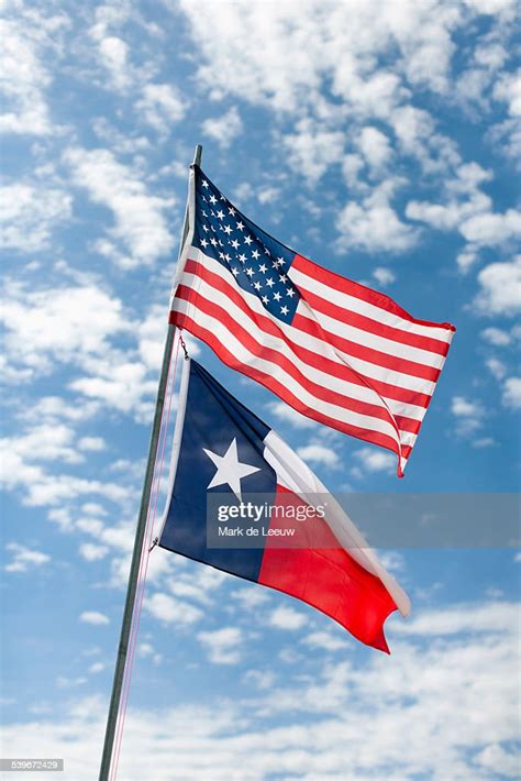 Usa Texas American And Texas Flags Against Cloudy Sky High Res Stock