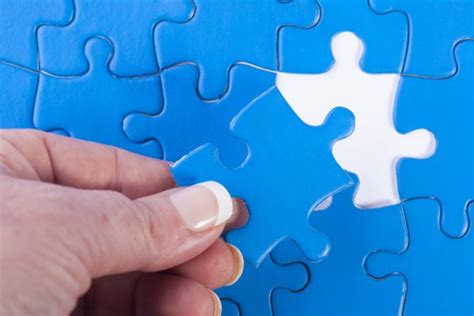 Womans Hand Placing Jigsaw Puzzle Piece Off Different Color Sig
