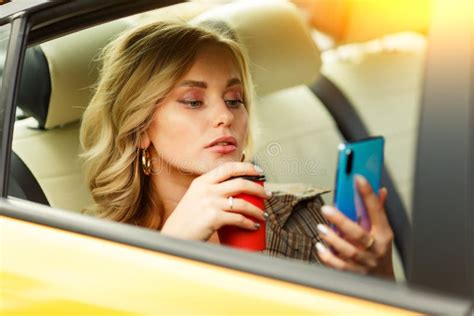 Photo Of Blonde In Red Dress Sitting In Back Seat Of Yellow Taxi With