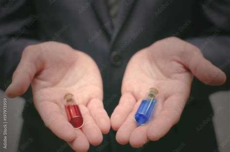 Blue And Red Pill Essential Liquid In Business Man Hands Choosing Of