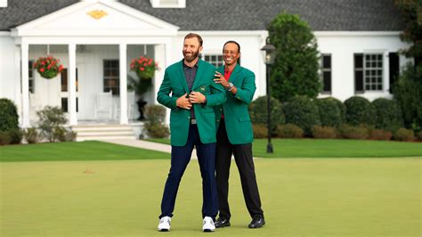 Dustin Johnson Is Awarded The Green Jacket By Masters Champion Tiger