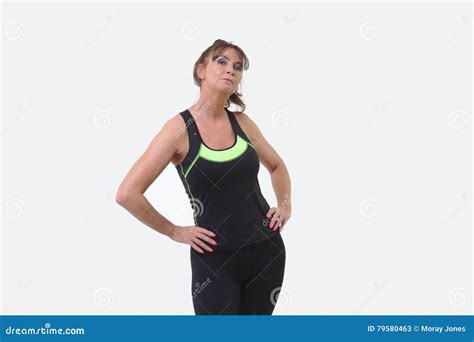 Attractive Middle Aged Woman In Sports Gear In Challenging Pose Stock