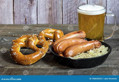 oktoberfest traditional food german sausages bratwurst with sauerkraut beer and pretzels