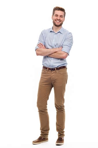 Full Length Portrait Of Young Man Standing On White Background Stock