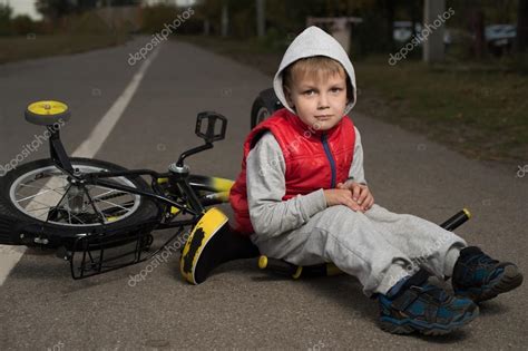 The Boy Fell Off His Bicycle — Stock Photo © Irinasidorenko 84351952