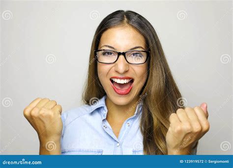 Happy Determined Young Woman With Raised Hands Shouting And Celebrating