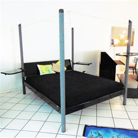 Metal poles or wooden beams connect the bottom bed (called the bottom bunk) to the top bed (called the top bunk). 1980s Canopy Bed Dark Lacquer, Adjustable Shelves, Sormani, Italy For Sale at 1stdibs