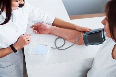 Measuring Blood Pressure Young Woman Have A Visit With Female Doctor