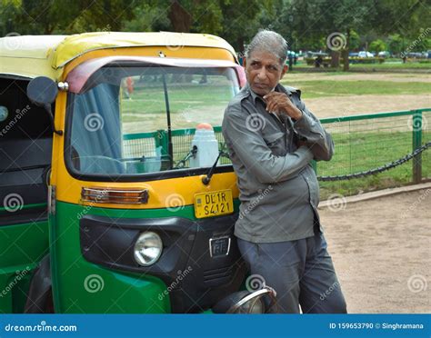 An Indian Auto Driver Waiting For Passengers In Front Of India Gate In