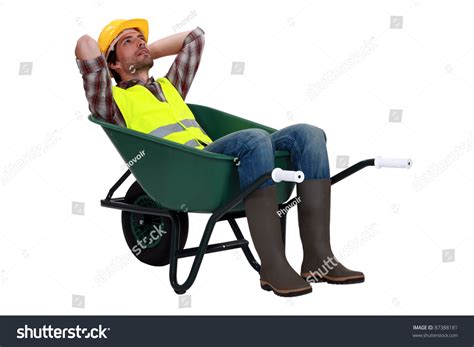 Construction Worker Resting In A Wheelbarrow Stock Photo 87388181