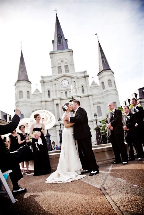 The Happy Couple Kissing During Their Ceremony In Front Of A Beautiful