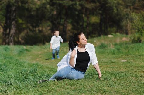 Stilish Mother And Handsome Son Having Fun On The Nature Happy Family Concept Stock Image