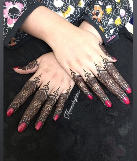 Two Hands With Henna Tattoos On Them