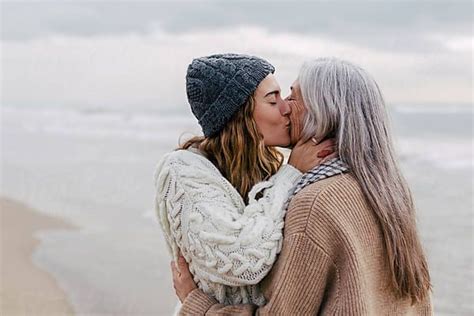 Daughter Kissing Her Mother On The Beach By Stocksy Contributor