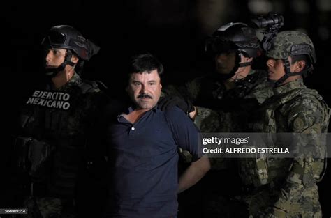 Drug Kingpin Joaquin El Chapo Guzman Is Escorted To A Helicopter At