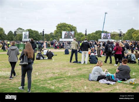 People gather in Hyde Park, London, where the TV coverage of the late