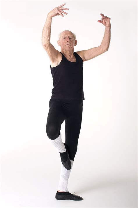 An Older Man In Black Shirt And Leggings Doing A Dance Move With One Hand
