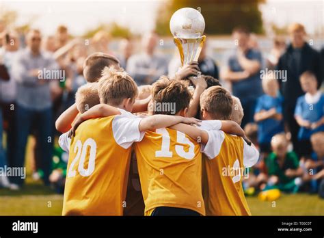 Kids Holding Golden Cup Boys Winning Soccer Championship Children