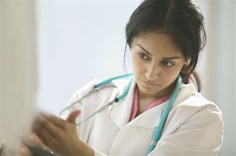 Female doctor examining a patient - Asuragen | Asuragen