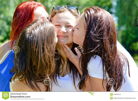 4 Beautiful Cute Girls Friends Having Fun Kissing Each Other Happy