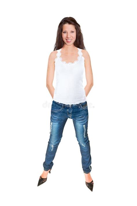 full length portrait of a beautiful smiling woman wearing blue jeans