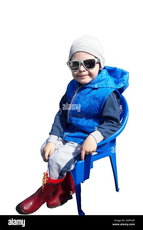 Pictured In The Photo Little Boy Sitting On A Chair On A White