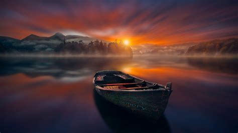 Calm Lake With A Boat At Sunset Wallpaper Backiee
