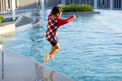 Cute Asian Boy Jumping Into Underwater At Swimming Pool Stock Photo