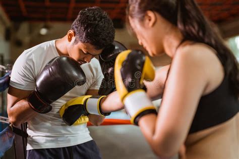 A Female Boxer Punching The Male Boxer On His Stomach Stock Photo