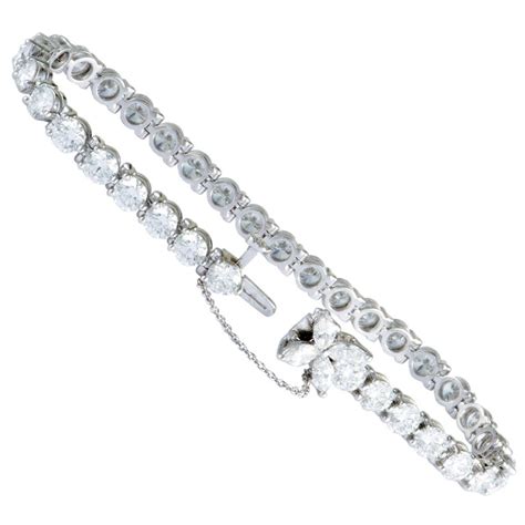 Silver bracelet w/ heart pendant. Tiffany and Co. Victoria Diamond Platinum Tennis Bracelet ...
